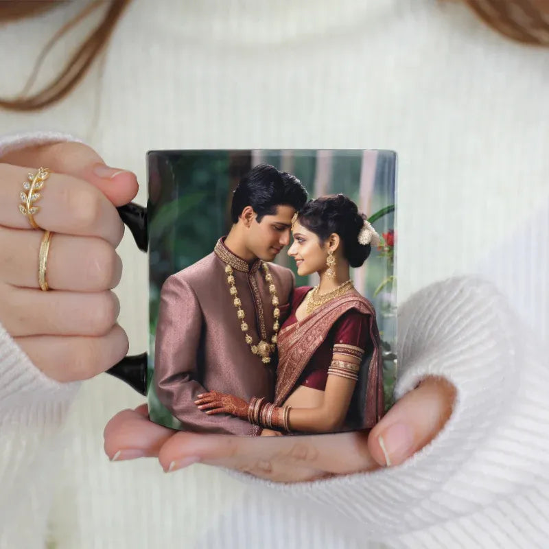 Person holding a mug with a printed image of a couple in traditional attire.