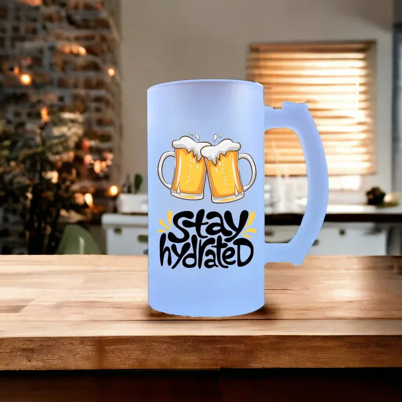 Light blue mug with beer graphics and 'Stay Hydrated' text on a wooden table.