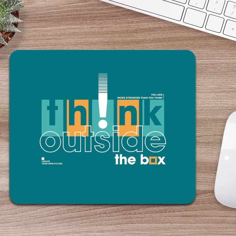 Teal mouse pad with motivational quote on a wooden desk