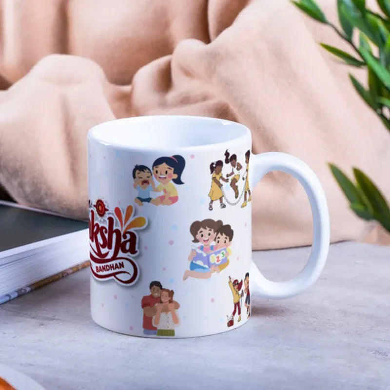 White mug with colorful illustrations and 'Aksha' branding on a table.