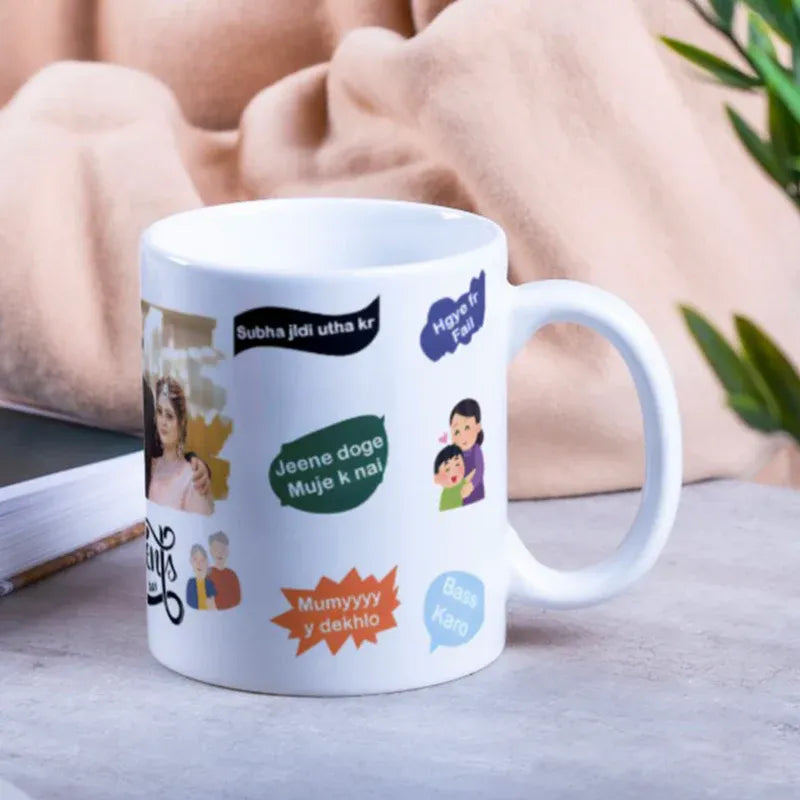 White mug with colorful text and images on a surface with a blurred background