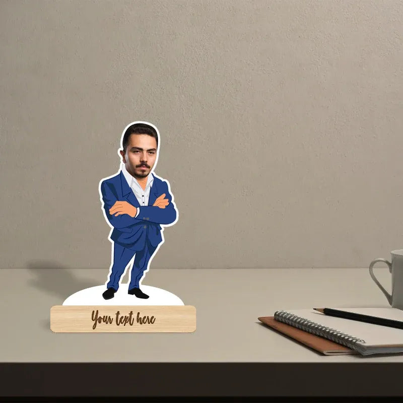 Mannequin head in a blue suit on a stand with 'Your text here' placeholder, placed on a desk with a notebook and mug.