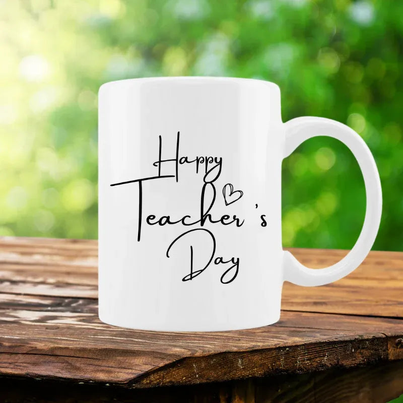 White mug with 'Happy Teacher's Day' text on a blurred background