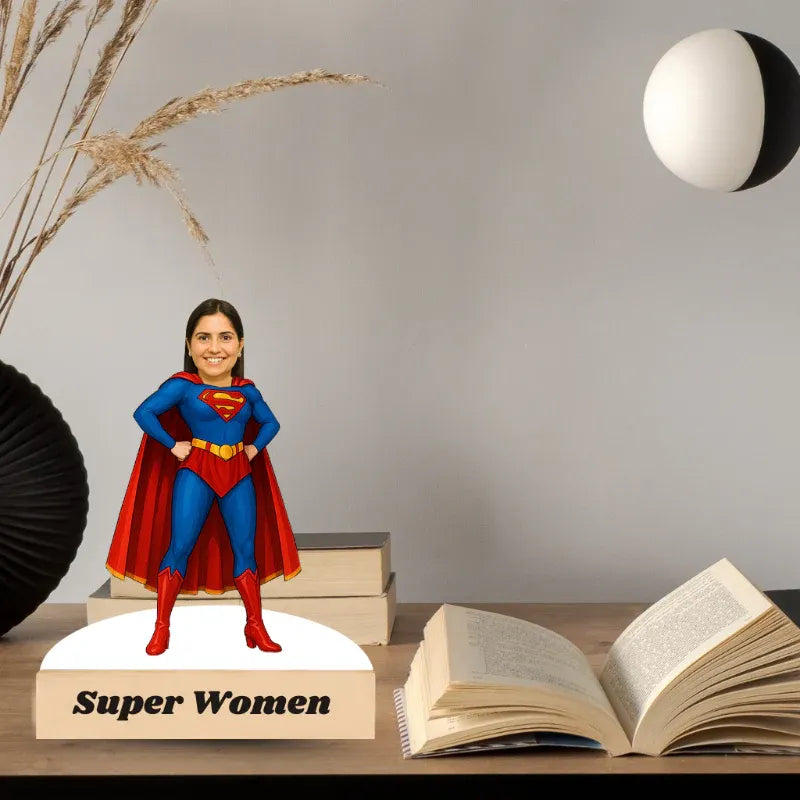 Superman figurine on books with 'Super Women' text, open book, and decorative elements.