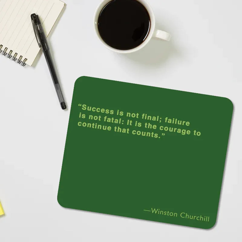 Green coaster with Winston Churchill quote on a desk with coffee and pen