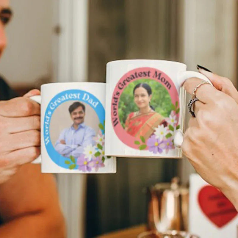Two mugs with personalized photos of a man and a woman, labeled 'World's Greatest Dad' and 'World's Greatest Mom'.