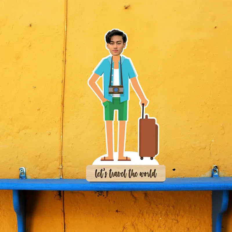 Figurine of a person with a suitcase on a stand against a yellow wall.