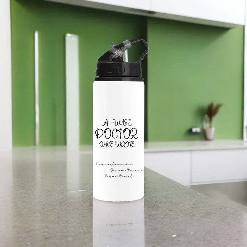 White water bottle with black text on a kitchen counter