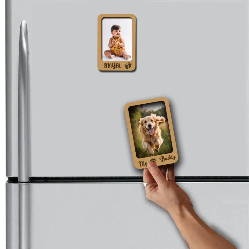 Hand placing a wooden photo frame magnet on a refrigerator with a dog picture.