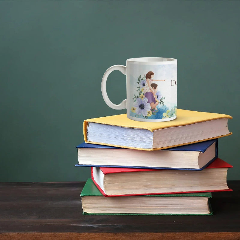 Personalized daughter coffee mug displayed on stack of books green background.