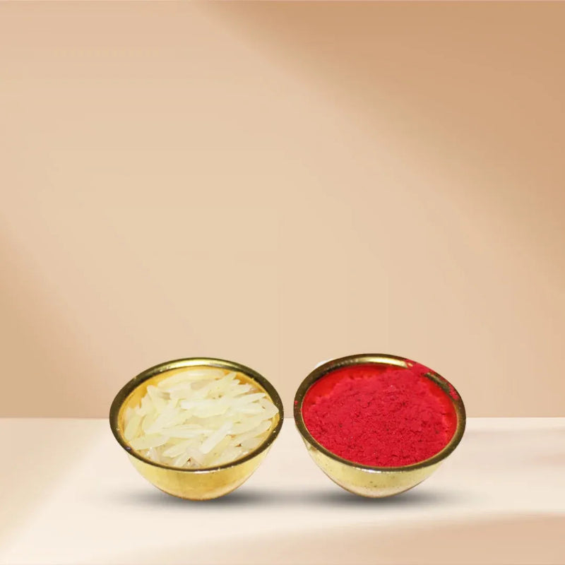 Two small gold bowls on a light beige surface against a warm beige background. One bowl contains white shredded material, and the other contains bright red powder.