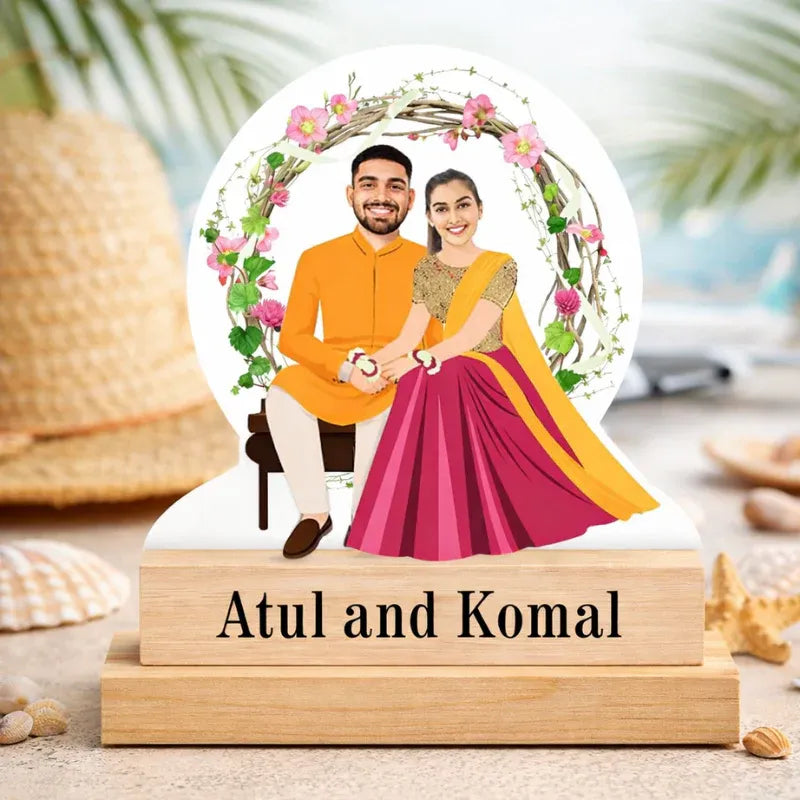 MDF cut caricature of an Indian couple with realistic faces, mounted on a wooden base with personalized name text