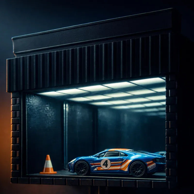 Blue sports car with number 4 in a dark garage setting