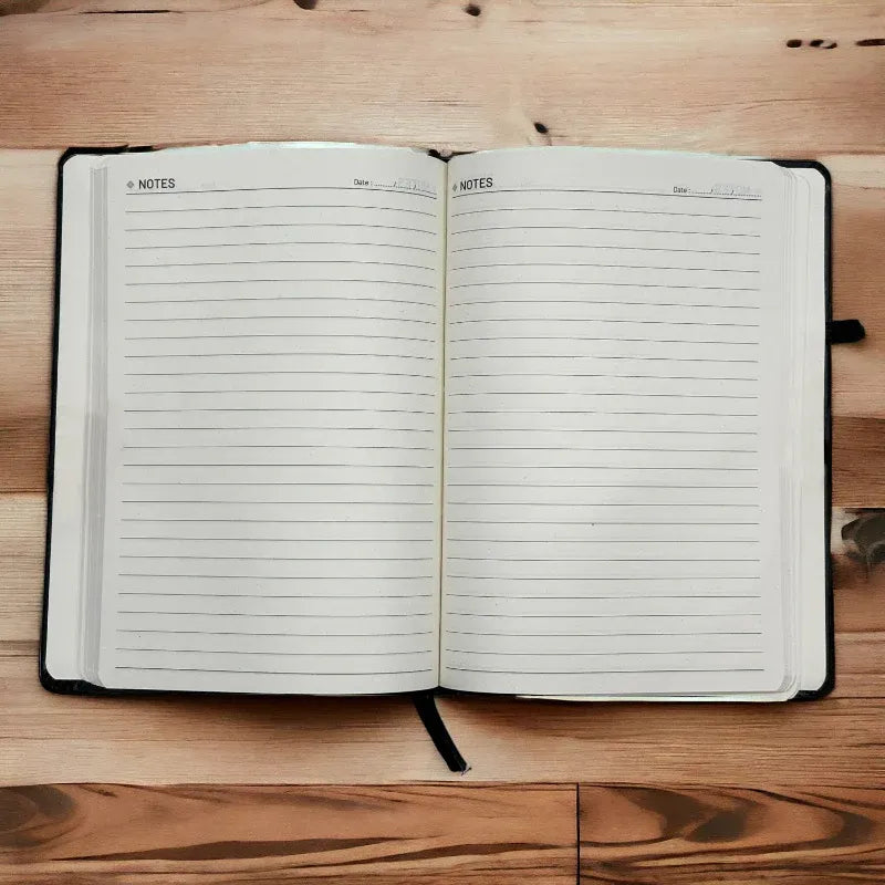 Open notebook with lined pages on a wooden surface