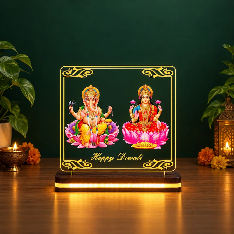 Laxmi Ganesh table lamp with Happy Diwali text glowing on a wooden base, green backdrop