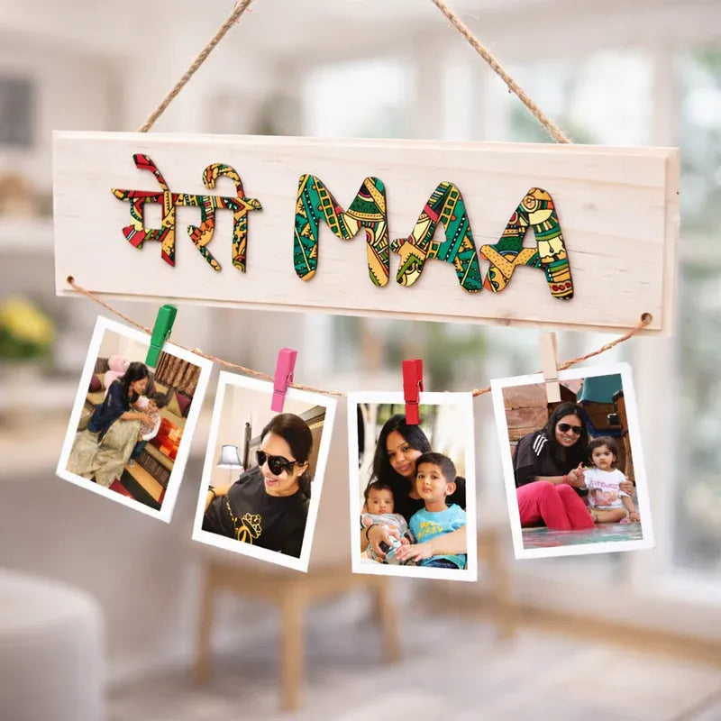 Decorative mother day sign with colorful letters spelling 'Maa' and family photos hanging below.