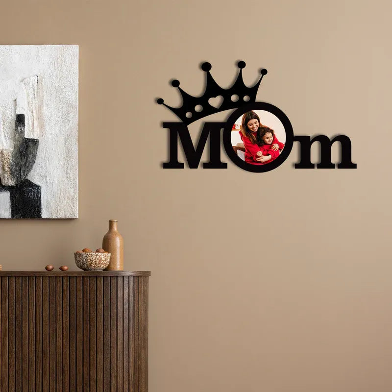 Decorative photo frame wall art with 'Mom' and a photo of a woman and child on a beige wall.