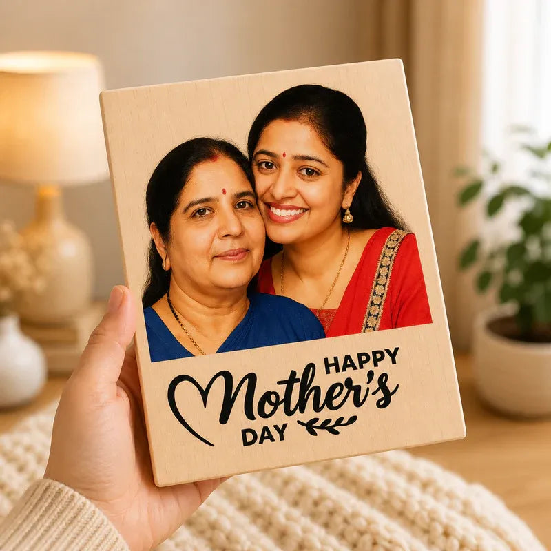 Hand holding a wooden photo frame with a picture of two women and 'Happy Mother's Day' text.