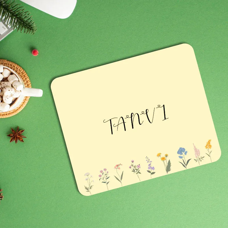 custsom mouse pad with your photo and text on a green surface with decorative items.