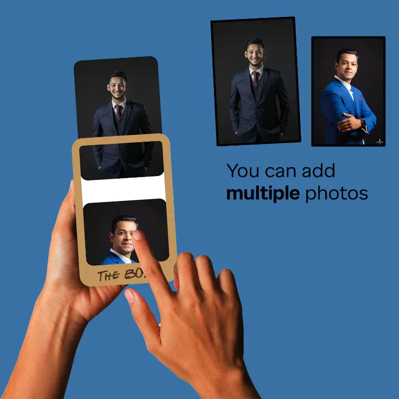 Hand holding a photo album with multiple portraits on a blue background