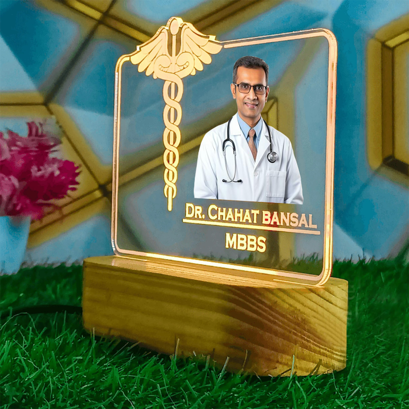 Decorative plaque with a doctor's photo and name on a grassy surface