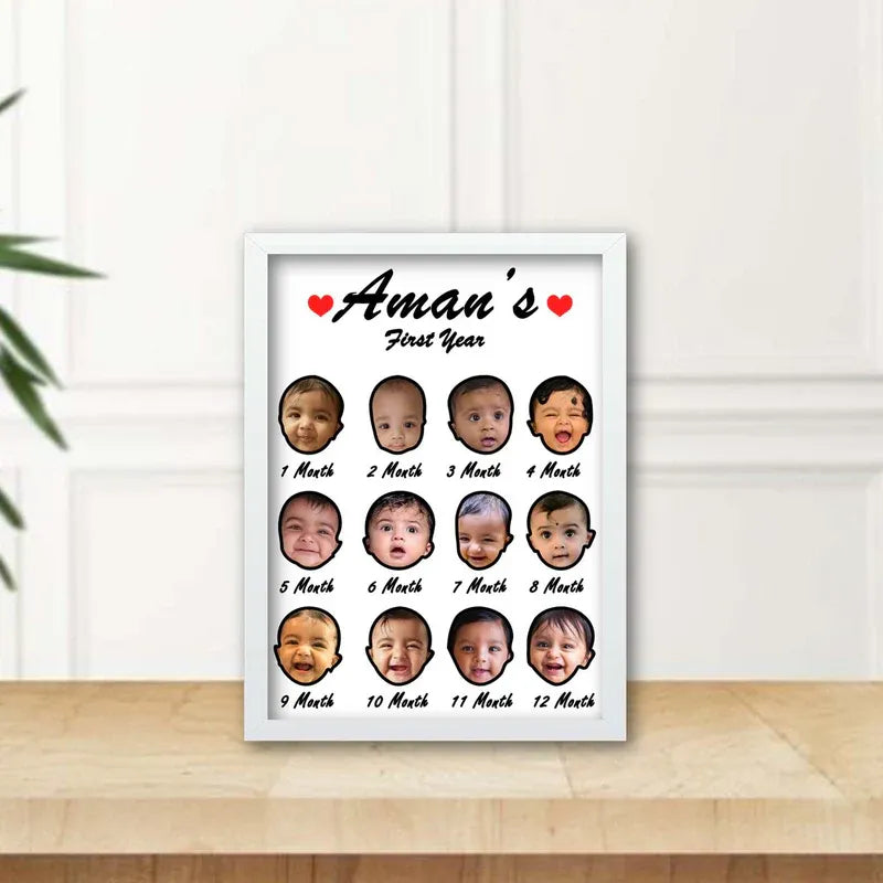 My first year photo frame — white wooden frame with 12 monthly baby photo collage and baby name, desk display on wooden surface.