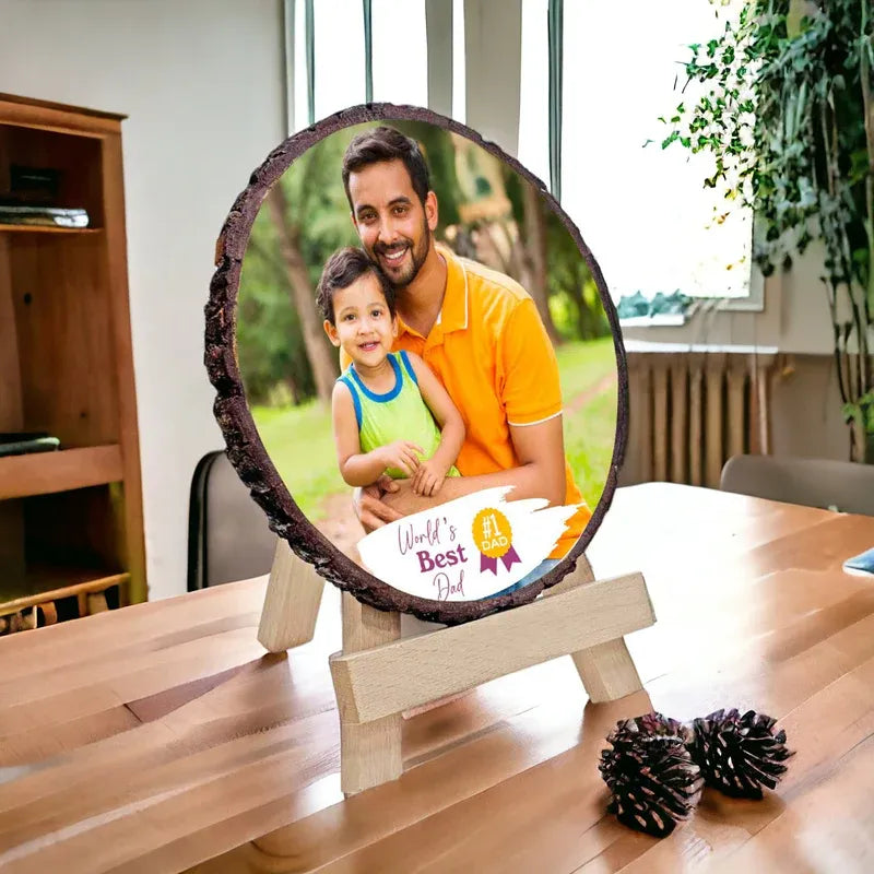 Round photo frame with a father and child on a wooden stand in a home setting.