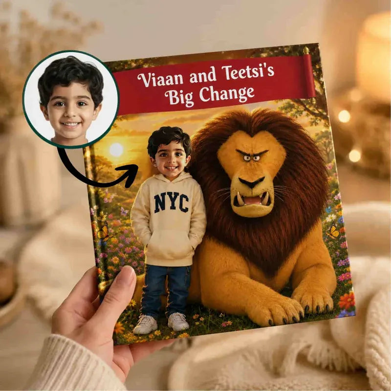 A hand holds a personalized children's book titled 'Viaan and Teetsi's Big Change' in a cozy indoor setting. The cover features a custom photo of a young boy in an NYC sweatshirt standing next to an angry lion, with a circular inset showing the original photo of the boy.