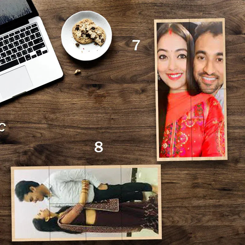 Wooden photo cube on a wooden desk with a laptop and cookie.