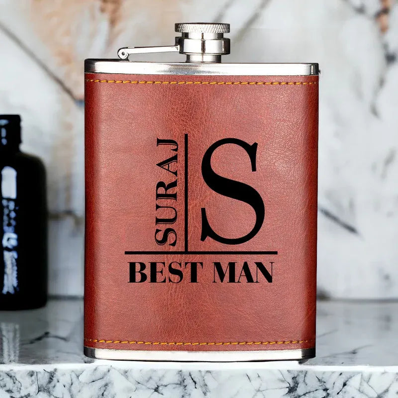Brown leather flask with engraved text on a marble surface