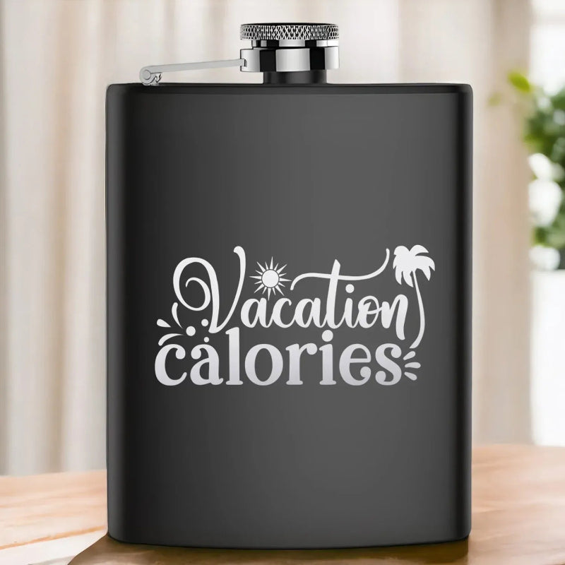 Black flask with 'Vacation calories' text on a wooden surface