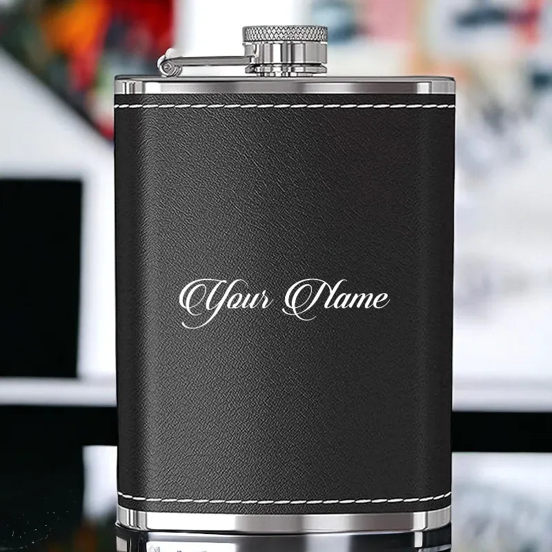 Black leather flask with silver cap on a blurred background