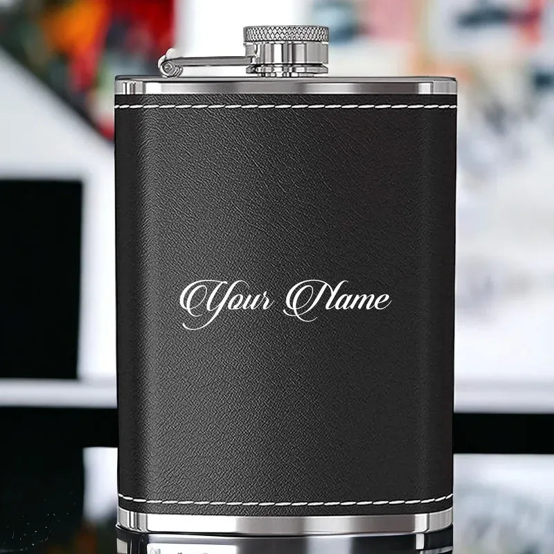 Black leather flask with silver accents on a blurred background