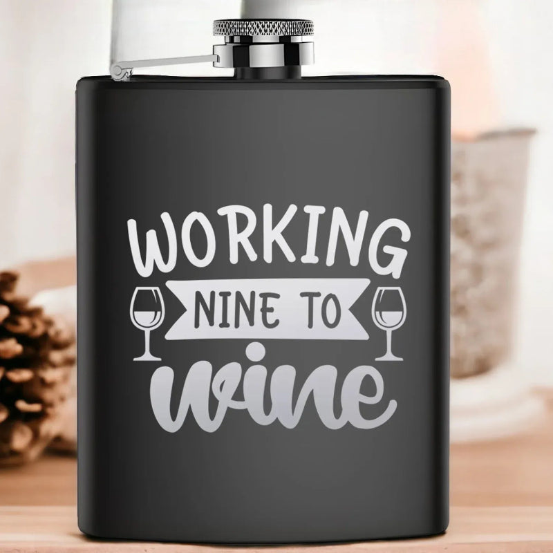 Black flask with 'Working Nine to Wine' text on a blurred background
