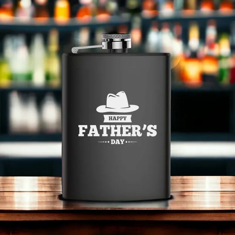 Black flask with 'Happy Father's Day' text and hat graphic on a bar background