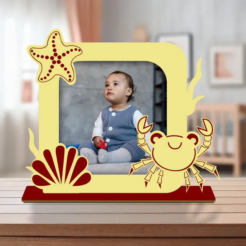 Decorative photo frame with sea-themed design featuring a child in a room.