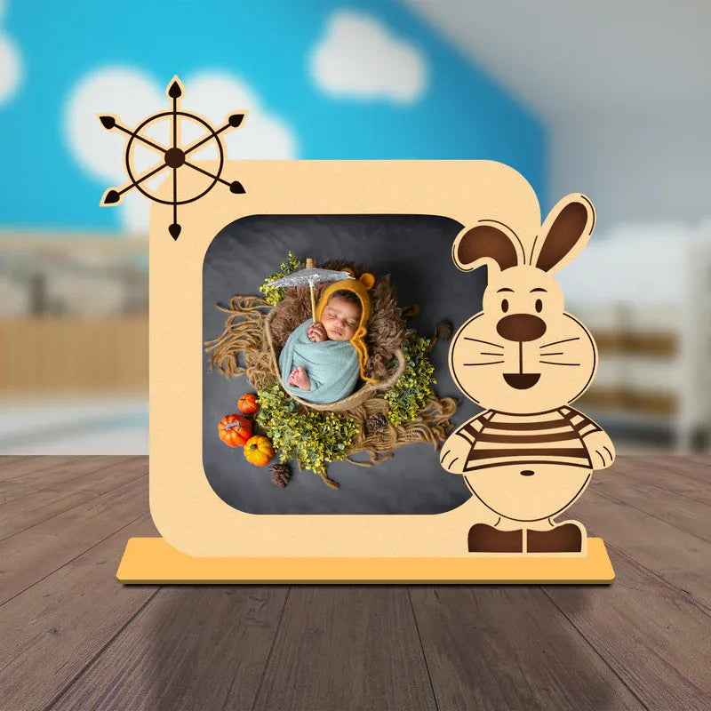 Wooden photo frame with a cartoon rabbit design on a wooden surface.