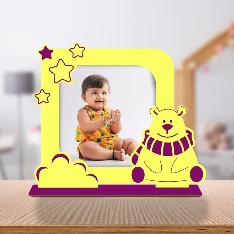 Yellow photo frame with a bear design on a wooden surface