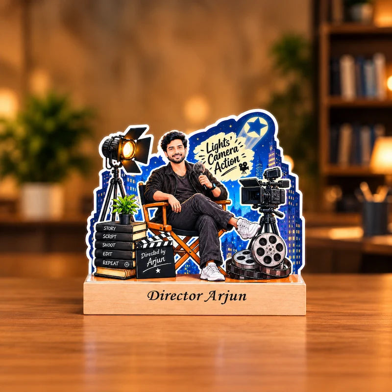 Personalized film director caricature of a man in a director’s chair on a wooden base engraved “Director Arjun”