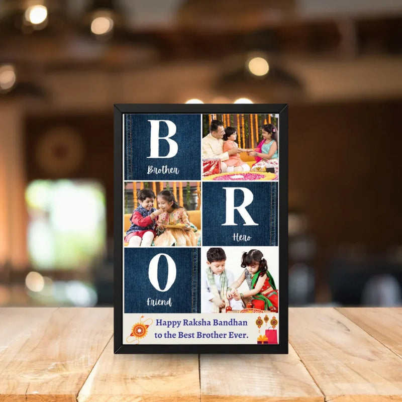 A personalized framed photo collage sign for 'Brother' displayed on a wooden table. The black frame features a 3x2 grid of dark blue textured panels with white letters spelling 'B R O' and words like 'Brother', 'Here', and 'Friend', along with custom family photos.