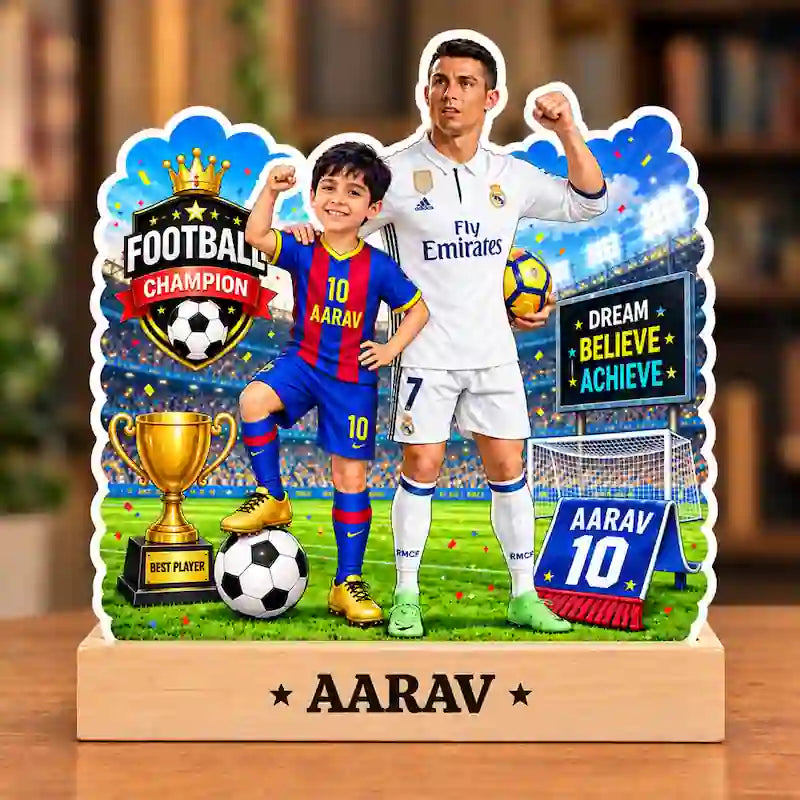 A personalized kids football player caricature front featuring a printed soccer scene with two children in Real Madrid-style jerseys, a trophy, a soccer ball, stadium background, and the name AARAV on the base.