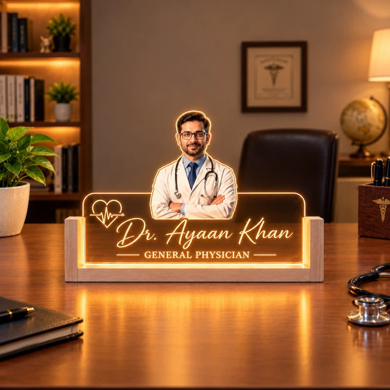 Personalized LED doctor caricature of Dr. Ayaan Khan, General Physician, with illuminated acrylic panel, warm LED glow and premium pine wood base on a doctor’s desk.