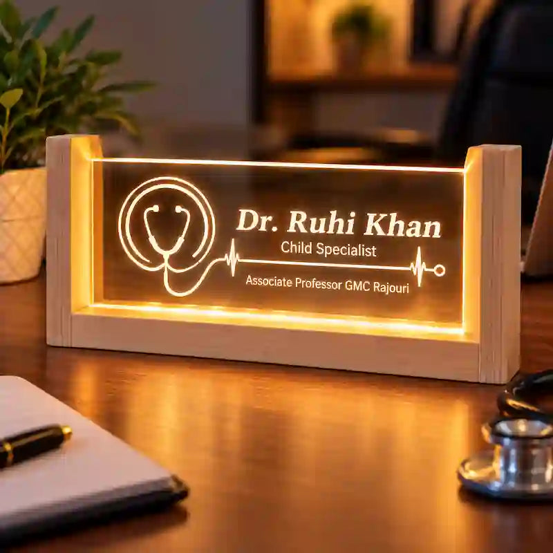 Personalized LED doctor name plate with a laser-engraved stethoscope and heartbeat design on a desk with a pen, notebook and stethoscope.