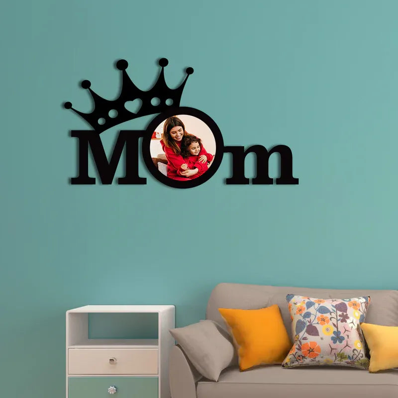 Decorative wall sticker with 'Mom' and a photo of a woman and child on a teal wall above a sofa.