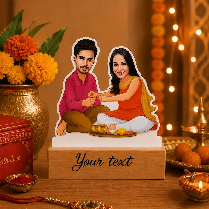 A custom cartoon sibling  cutout standee displayed on a wooden base with a placeholder text 'Your text'. The scene is decorated with orange marigold flowers, a brass pot, and warm string lights in the background.