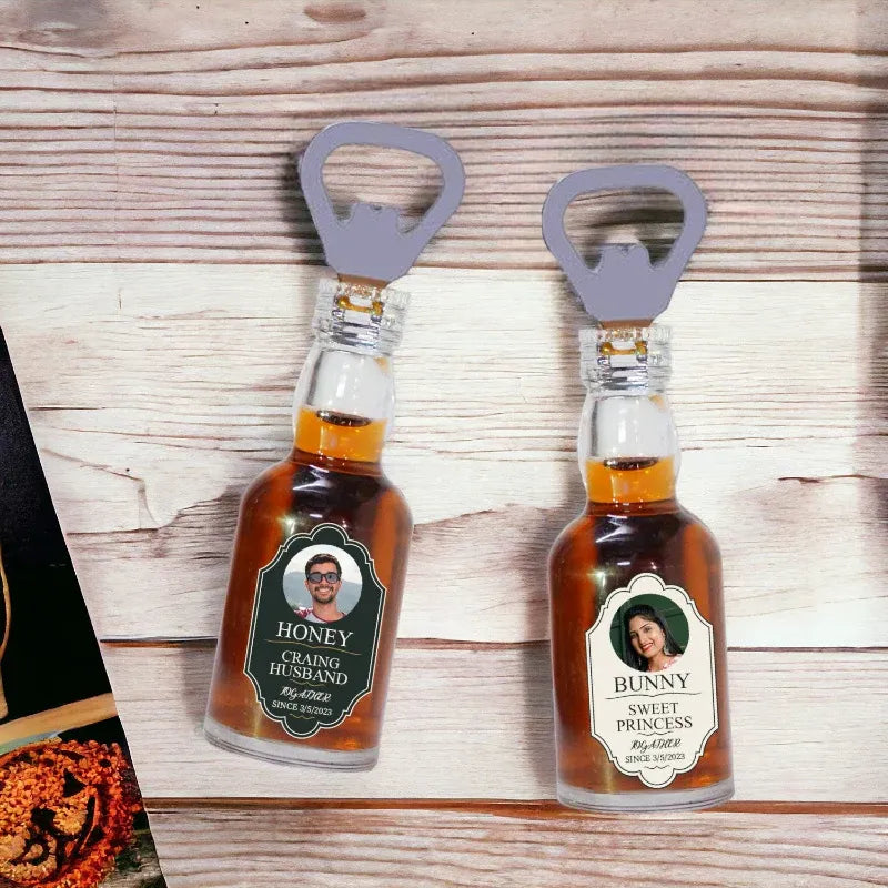 Two small bottles with labels and bottle openers on a wooden surface