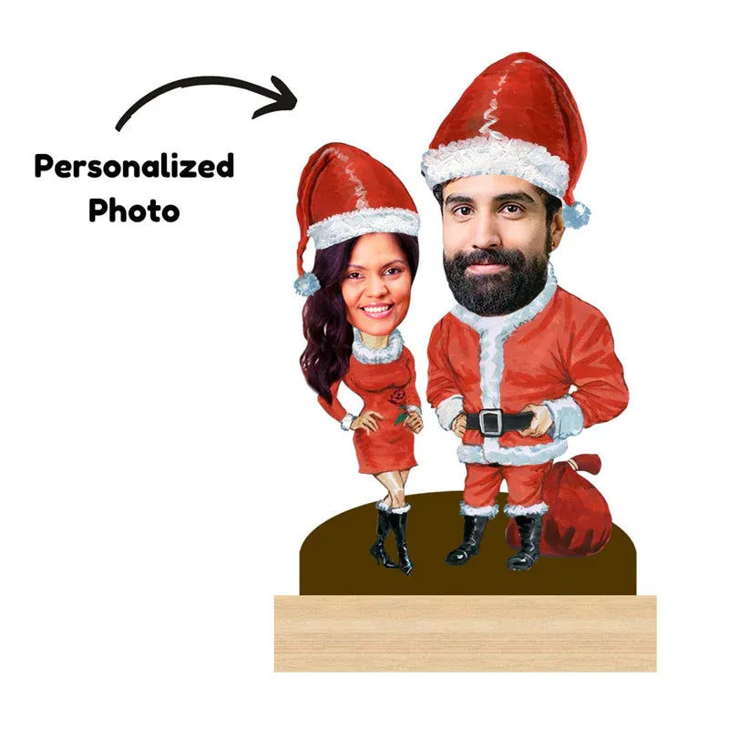 Bobbleheads of a man and woman in Santa Claus outfits with a personalized photo label.
