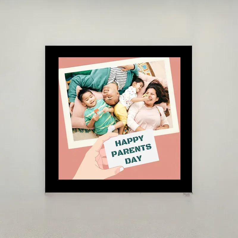 Framed photo of a family with 'Happy Parents Day' on a light gray background