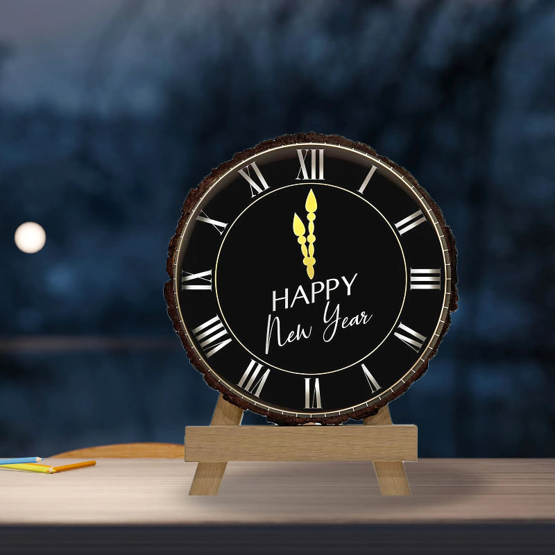 Round clock with 'Happy New Year' text on a wooden stand against a blurred night sky background.