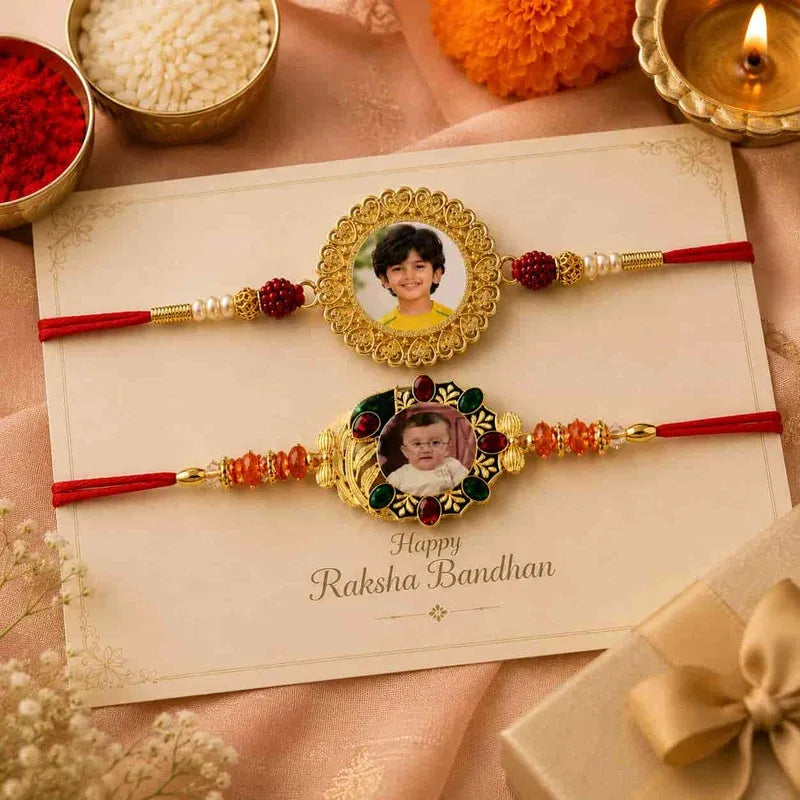 Two personalized Rakhi bands laid flat on a cream card with 'Happy Raksha Bandhan' text, surrounded by festive props including red and white powders, marigold flowers, a lit diya, and a gift box.